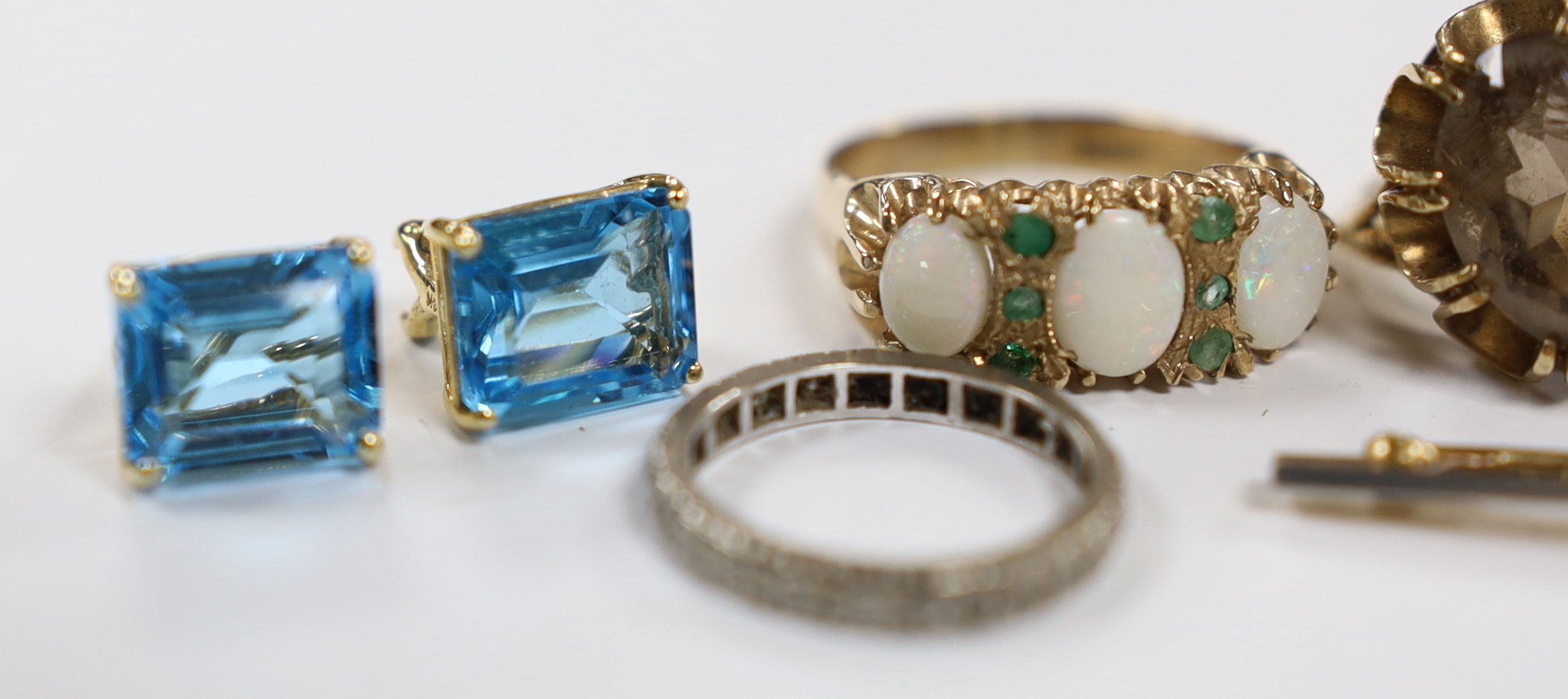 Assorted jewellery including a modern pair of 14k and blue topaz earrings, a pair of 375 and seed pearl cluster earrings, two 9ct gold and gem set rings including a white opal and emerald chip, a white metal and diamond